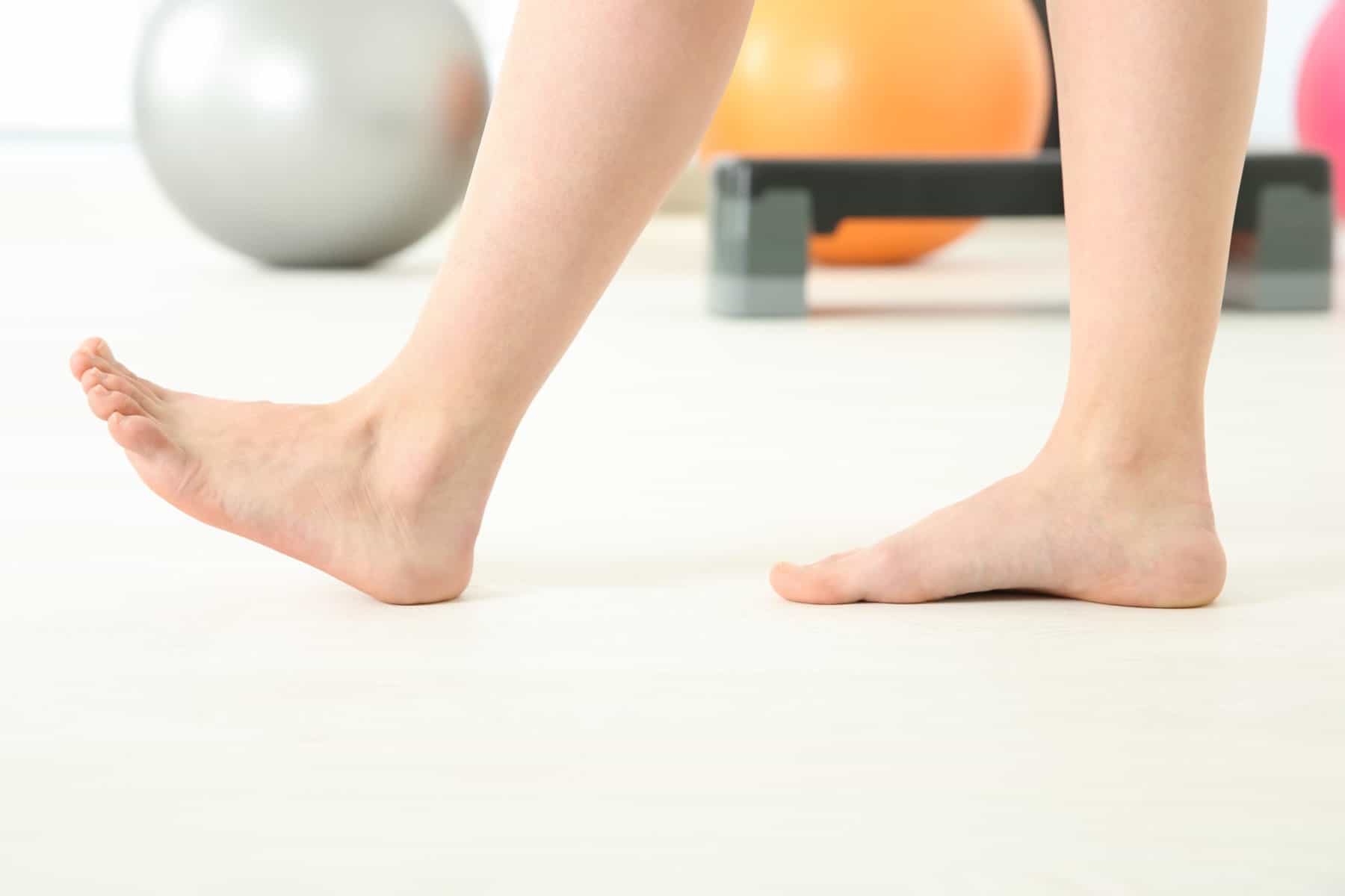 Cropped picture of a women's feet doing an ankle pump exercise.